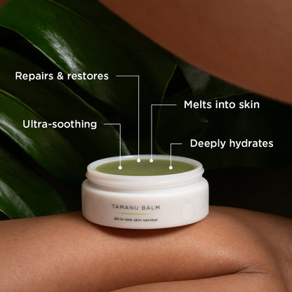 A container of Tamanu Balm, described as an "all-in-one skin saviour," is resting on a person's leg with a green leafy background. Text labels surrounding the balm highlight its benefits: "Repairs & restores," "Melts into skin," "Deeply hydrates," and "Ultra-soothing."